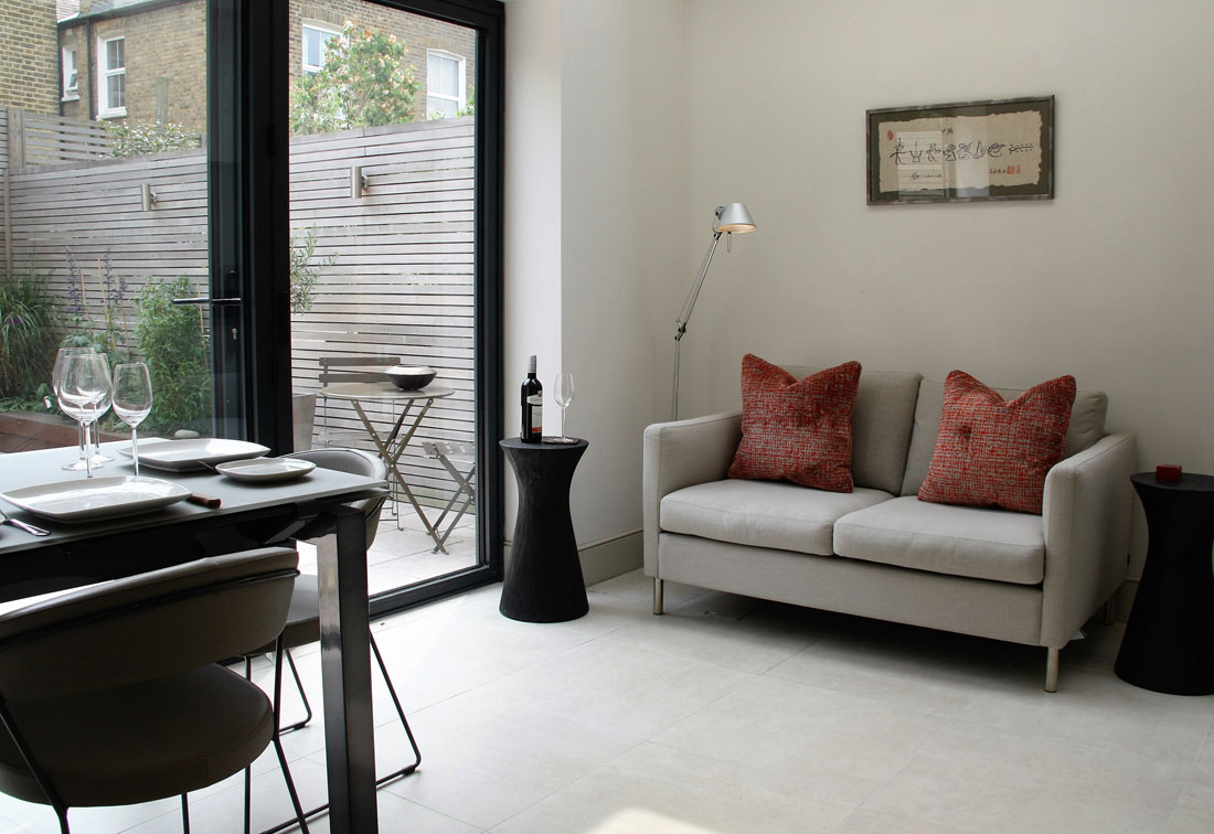 West Putney contemporary dining room and upholstered sofa by interior designer Suzi Searle