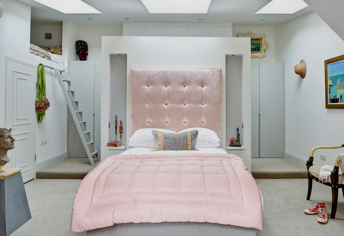 West London apartment master bedroom with bespoke cushioned headboard by Suzi Searle Interiors