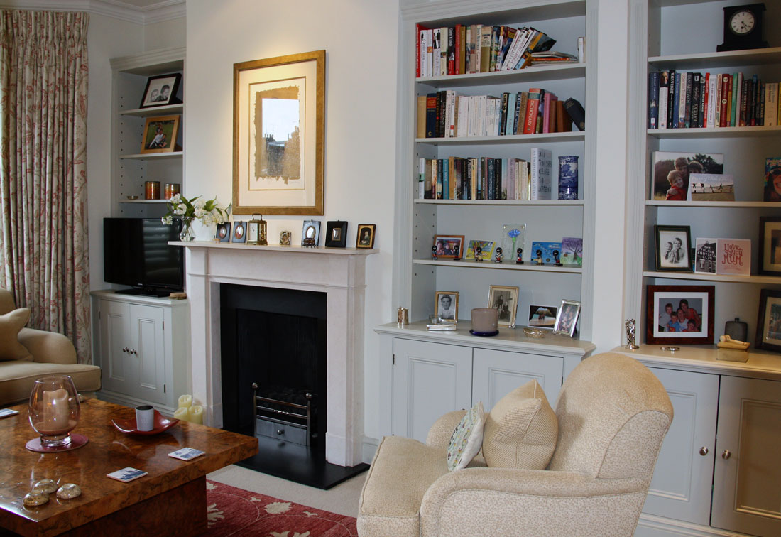Interior design of sitting room in Fulham showing shelves and the fireplace - interior decoration by Suzi Searle