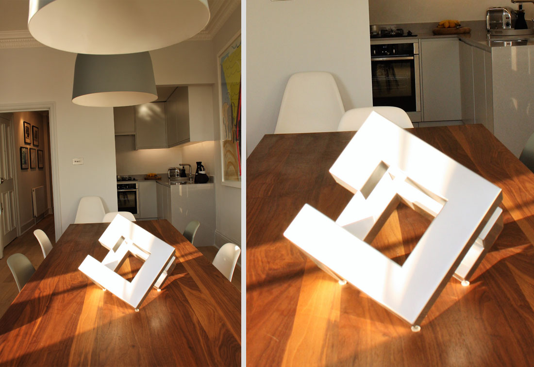 Kitchen / diner with artwork on wooden table, West London interior design