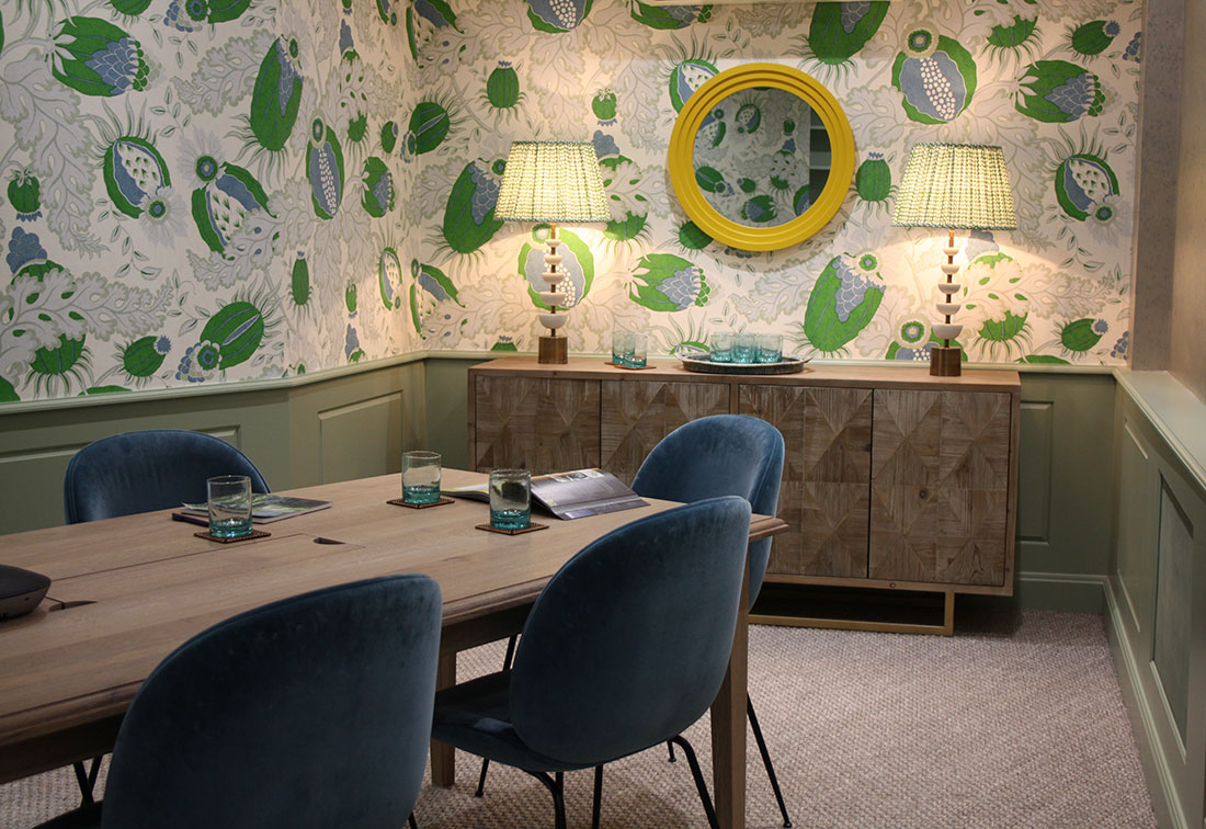 Bespoke interior design of a meeting room in an office with bold wallpaper and accessories