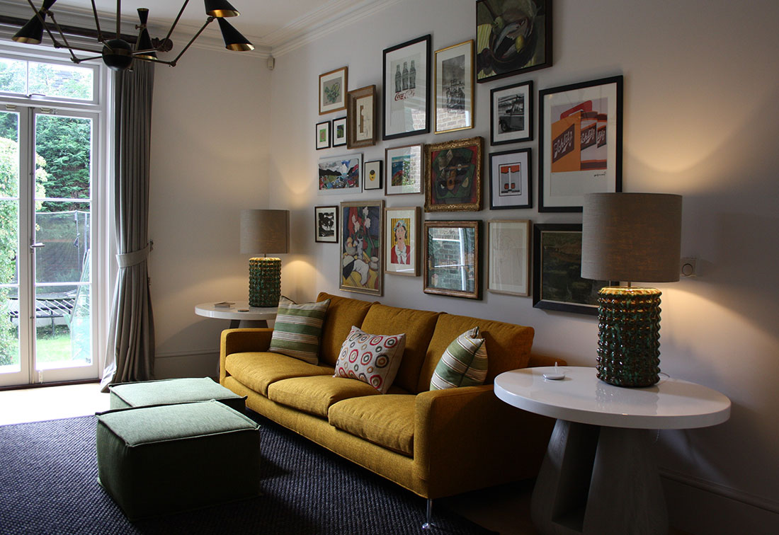 A wall of art hanging in a Higbury interior-designed home